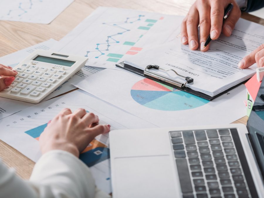 partial-view-of-man-studying-loan-agreement-and-businesswoman-using-calculator-while-sitting-at.jpg partial-view-of-man-studying-loan-agreement-and-businesswoman-using-calculator-while-sitting-at.jpg